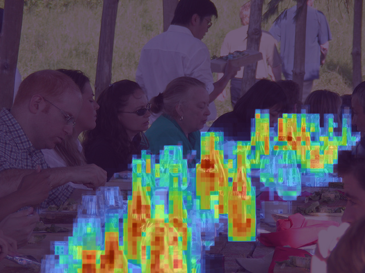 Activation overlay highlighting bottle-like regions in the table scene